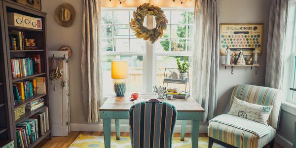 beige table with lamp and striped chairs in home office