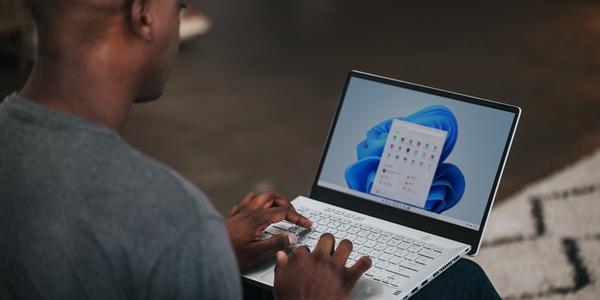 over shoulder photo of a person using a windows 11 laptop